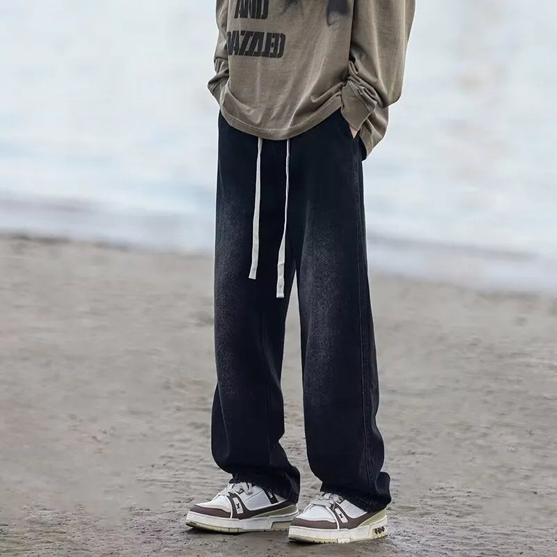 Men's blue straight-leg denim trousers with drawstring waist shown on hanger