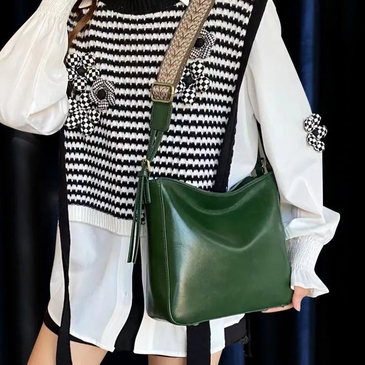 Women's black genuine leather shoulder messenger bag showing structured square shape and single strap.