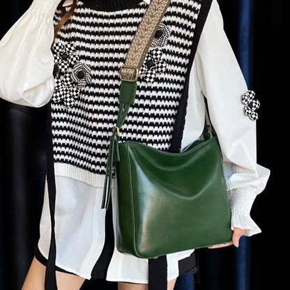 Women's black genuine leather shoulder messenger bag showing structured square shape and single strap.