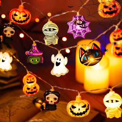 Battery-powered LED Halloween lights in various spooky designs including pumpkins, ghosts, and bats with warm white glow