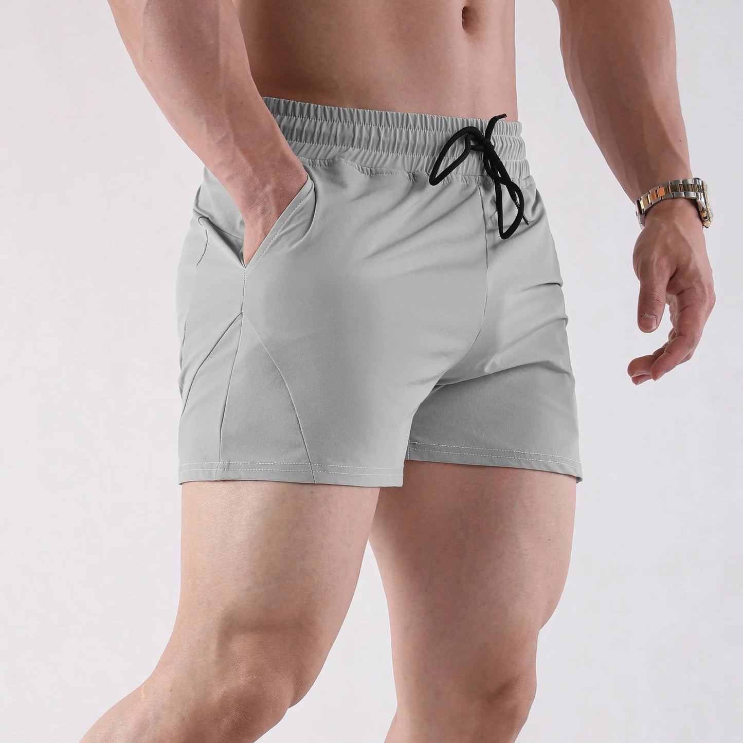 Men's thin grey polyester basketball shorts with an elastic waistband, shown laid flat.