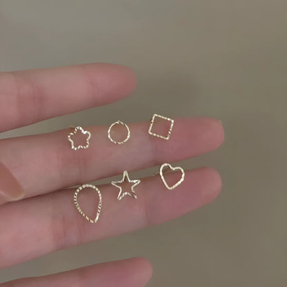 Pair of small spiral geometric ear studs with gold hollow thread finish in mixed material, shown in eight shape options.