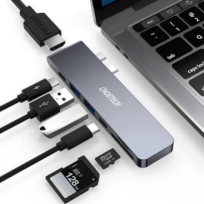 Silver aluminium USB-C hub adapter with SD card slot, Micro SD slot, HDMI, USB ports, and USB-C connector.