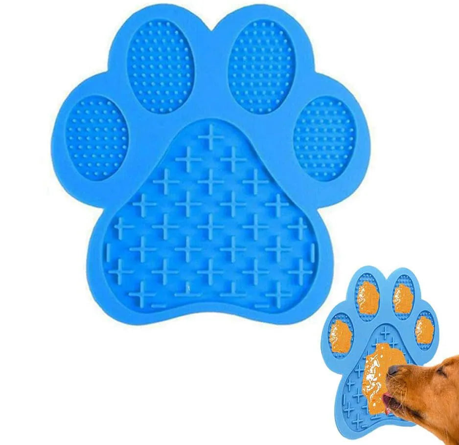 Bone-shaped blue silicone dog licking mat with suction cups on a tile surface