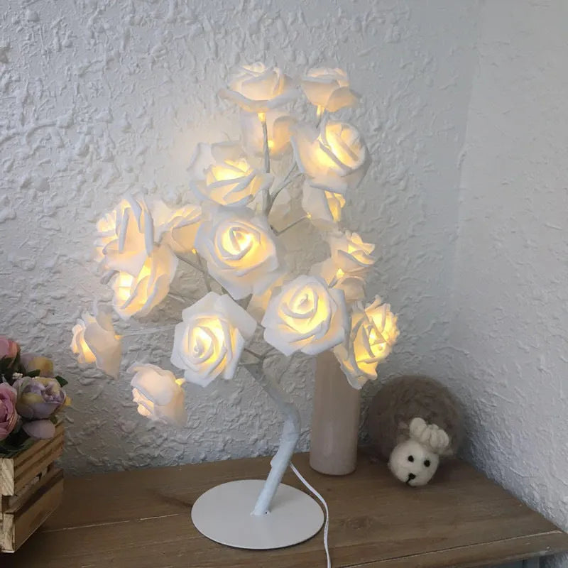 White and red rose flower LED lamp on a table with bonsai tree shape and warm white glow.