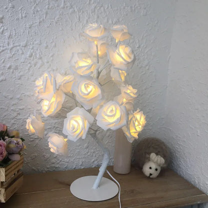 White and red rose flower LED lamp on a table with bonsai tree shape and warm white glow.