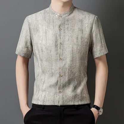 Man wearing a loose-fit grey linen blend short-sleeve shirt with a stand collar.
