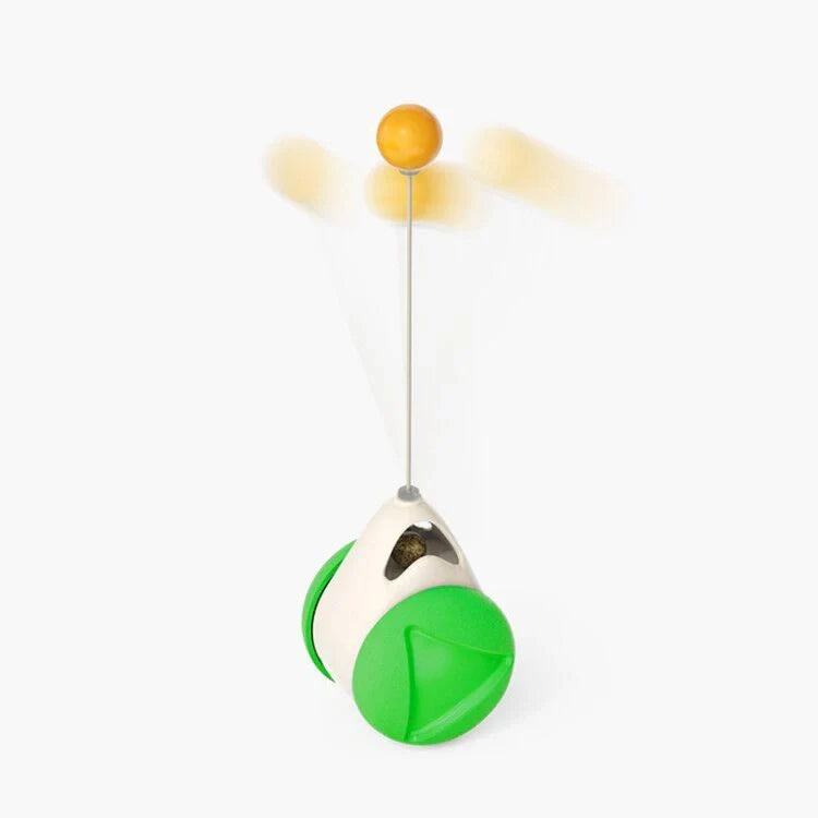 Cat playing with rotating windmill toy featuring luminous balls and suction base