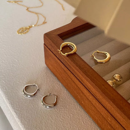 Small fat circle ear clip bracelet in white gold and yellow gold colours