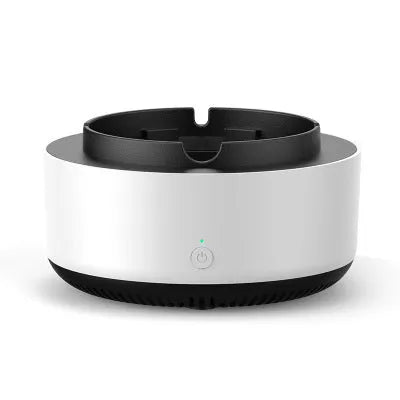 Grey intelligent electronic air purifier ashtray with fan, shown on a desk next to a cigarette.