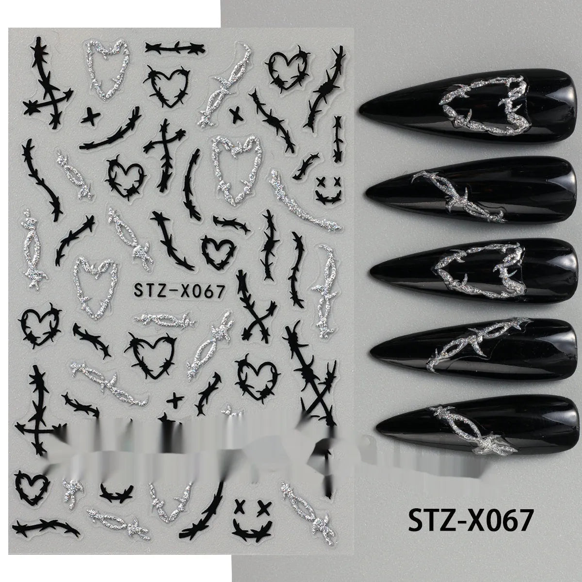 Assortment of black and silver nail sticker designs including cartoon and French tip patterns on a plastic sheet.