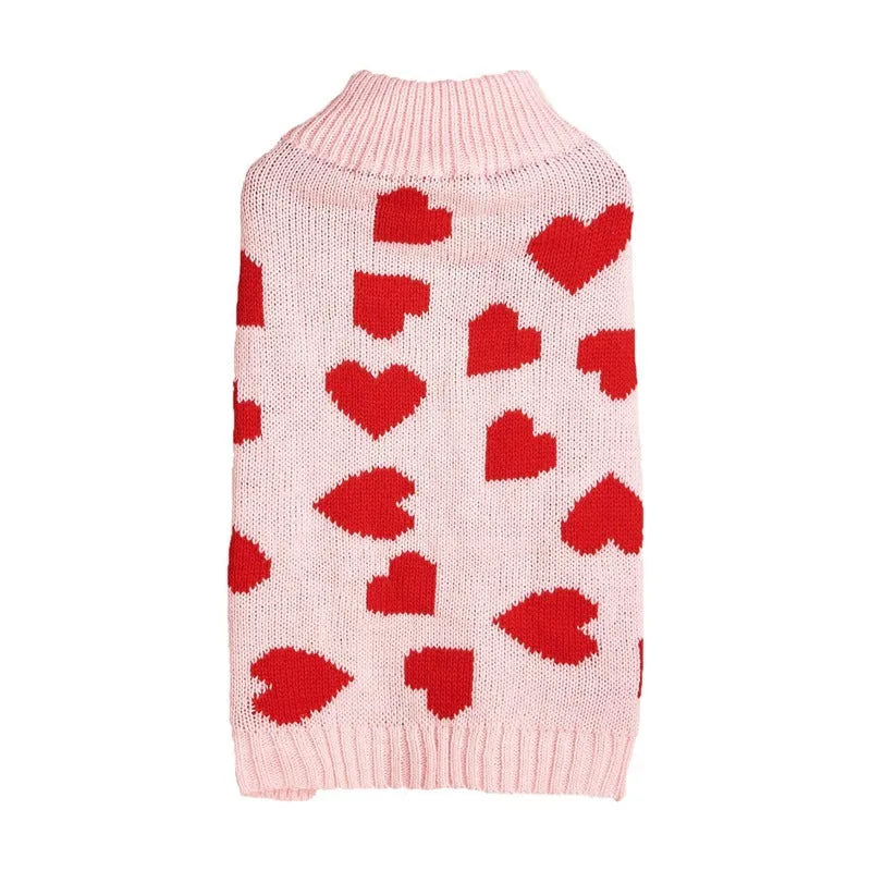 Dog wearing red love heart design sweater with bow decoration