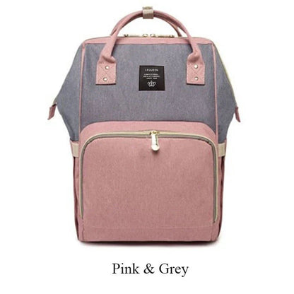 Stylish maternity diaper bag in various colors, featuring a paper bag design, separate bottle compartment, and discreet breastfeeding button.