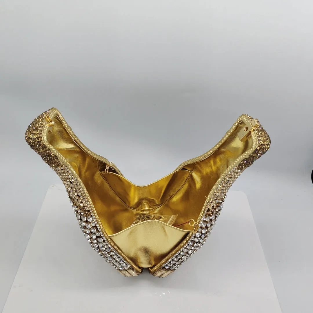 Gold hard-shell clutch bag shaped like a champagne bottle with a synthetic leather interior.
