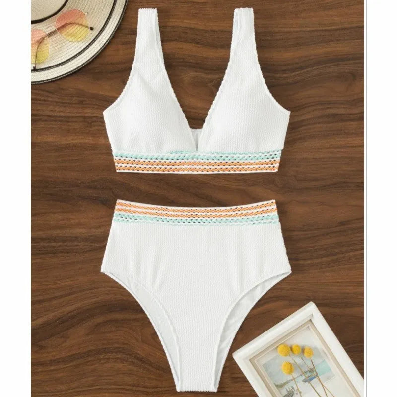 Women's high waist bikini set in solid pink colour, showing sleeveless top and briefs.