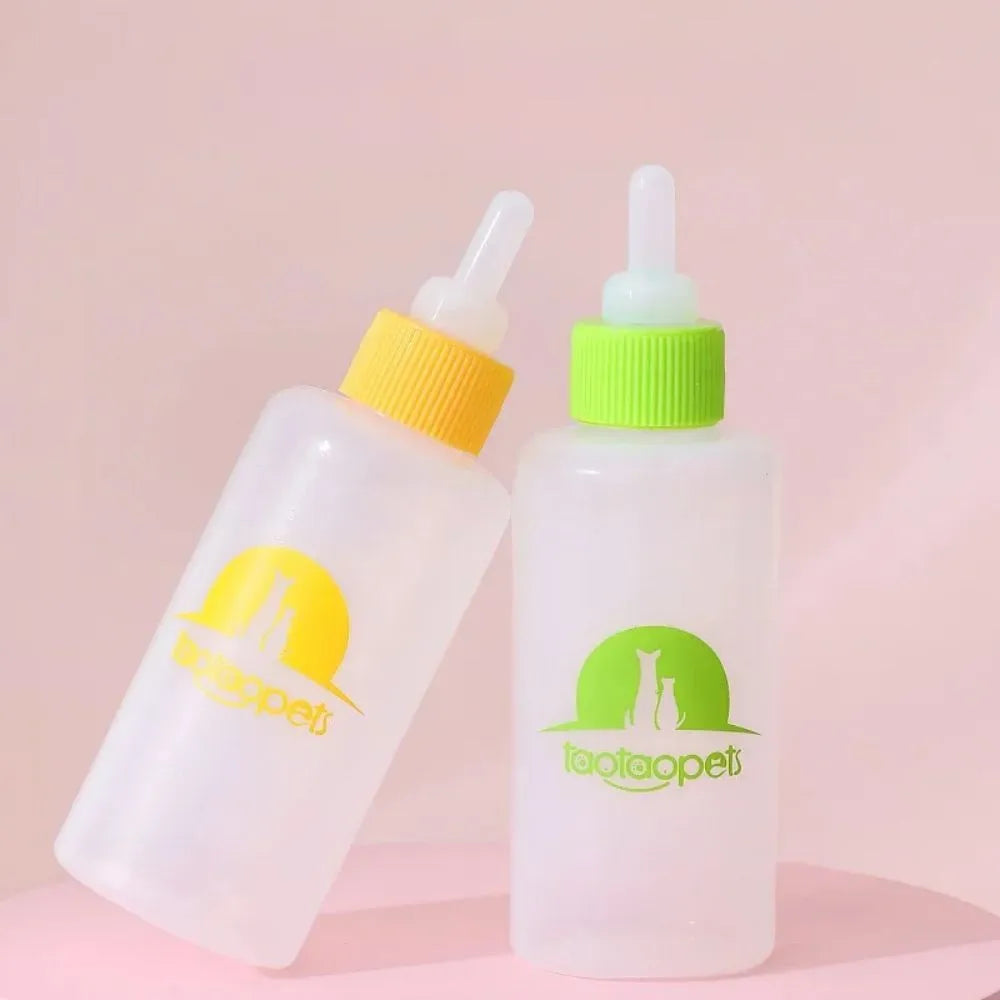 Set of four coloured pet milk bottles with silicone teats and a cleaning brush for small animals.