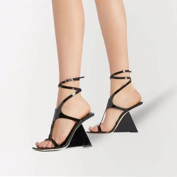 Black women's high heel sandals with a square toe and buckle strap, shown on a white background.