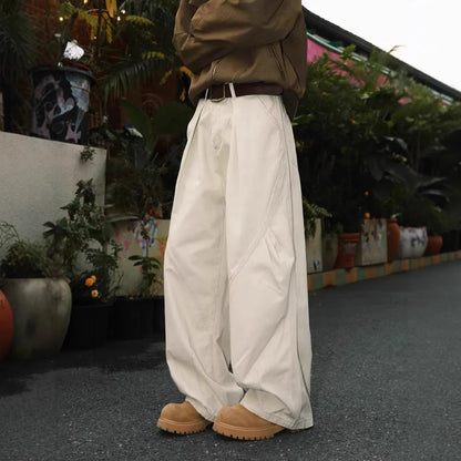 Man wearing pleated straight-leg trousers in a striped pattern with a micro elastic mid waist.