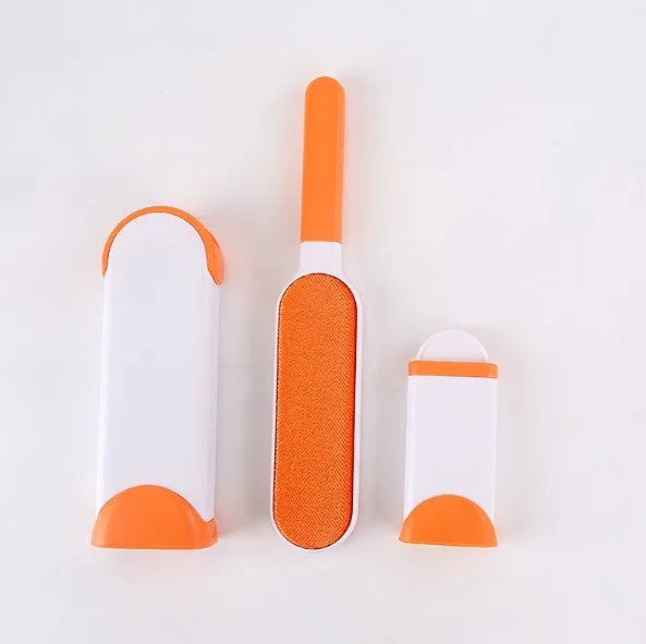 Blue reusable pet hair removal brush with double-sided head next to its self-cleaning base.