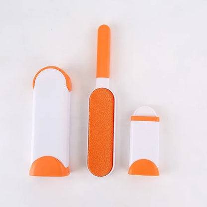 Blue reusable pet hair removal brush with double-sided head next to its self-cleaning base.