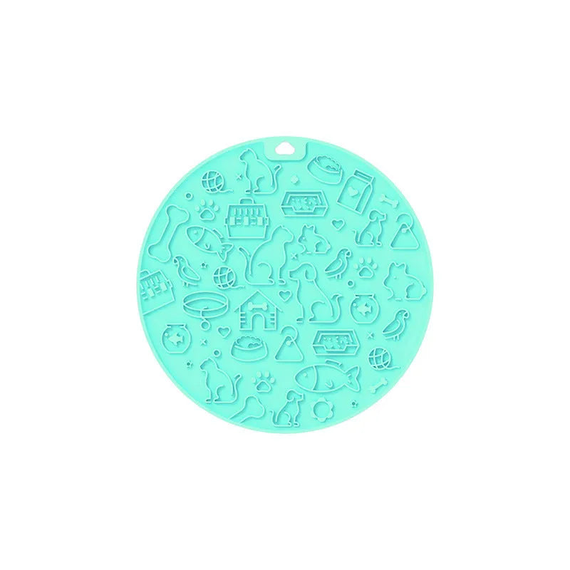 Round blue silicone pet licking mat with textured surface and a clear central suction cup, shown on a tile floor.