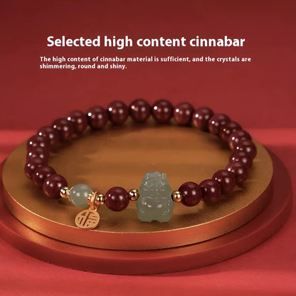 Natural Hetian jade bracelet with zodiac carvings and cinnabar accents in 8mm diameter