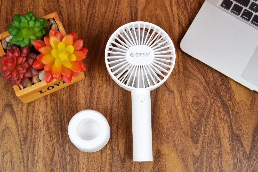 White ORICO FH1 portable USB rechargeable desk and handheld small fan with three speed buttons.