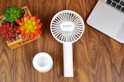 White ORICO FH1 portable USB rechargeable desk and handheld small fan with three speed buttons.