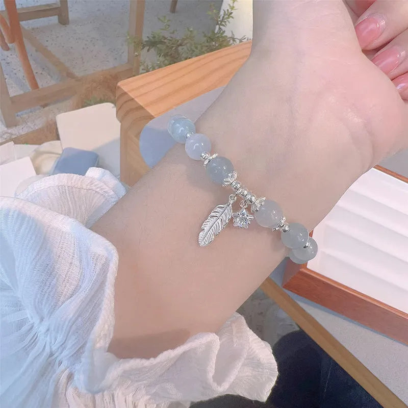Small white girl crystal bracelet with blue moonlight feather charm and Korean style design