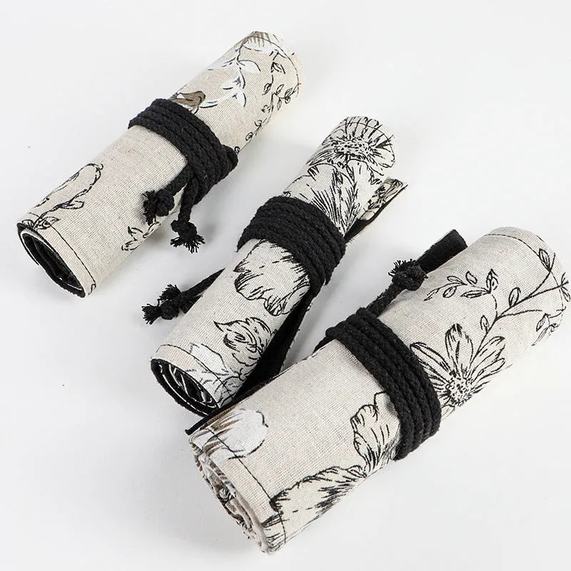 Black Peony printed cotton hemp pencil roll bag unfurled showing 24 or 72 pencil pockets.