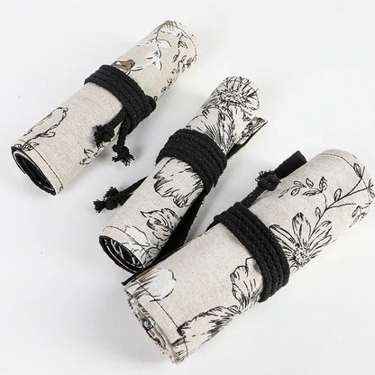 Black Peony printed cotton hemp pencil roll bag unfurled showing 24 or 72 pencil pockets.