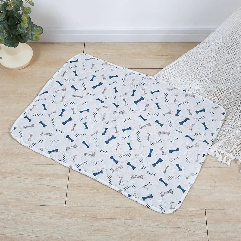 Reusable washable pet urine pad showing colourful animal pattern and waterproof backing.