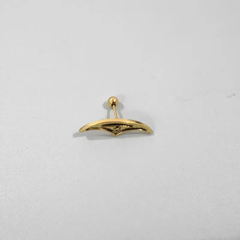 Close-up of a geometric spider web design on a gold-toned metal stud earring.