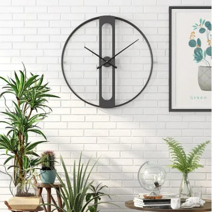Large round metal wall clock with black finish showing analogue dial, 50cm in diameter.