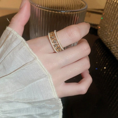 Elegant square ring with hollowed-out design and shimmering zircon stones, perfect for the stylish British woman