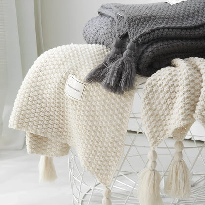 Fringed knitting blanket in beige colour showing 5cm fringe detailing and dense acrylic weave texture