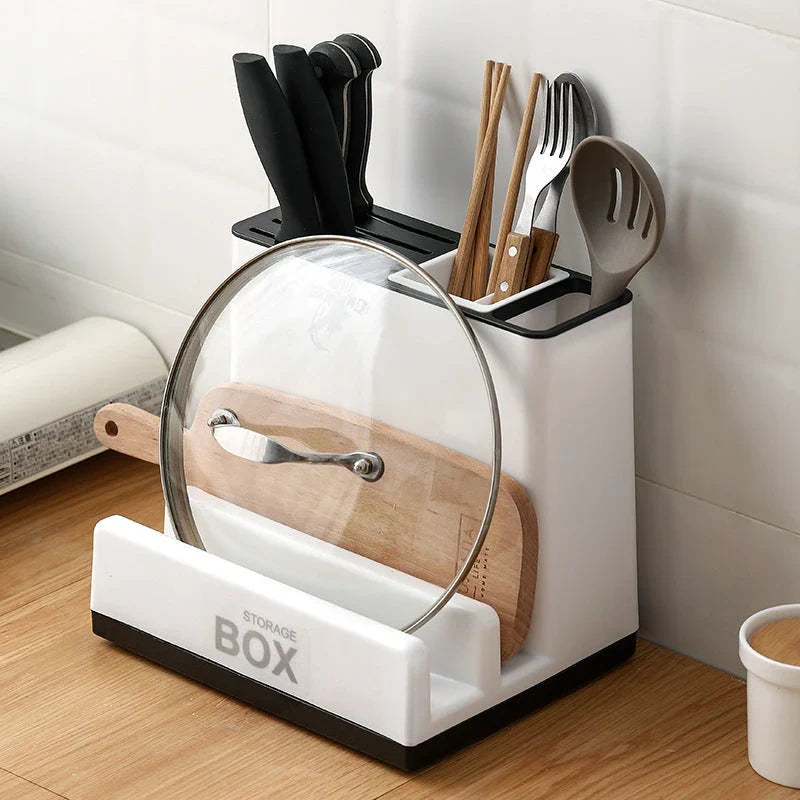 A modern, white plastic kitchen storage rack with integrated shelves for organizing cutlery, utensils, and tableware