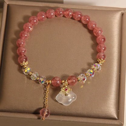 Women's strawberry quartz and white agate crystal bracelet with auspicious cloud charms on elasticated cord