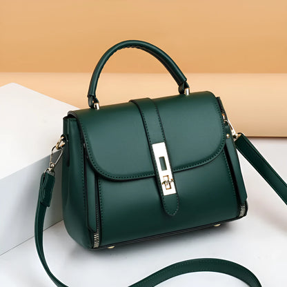 Women's soft black PU leather square messenger bag with a single shoulder strap on a table.