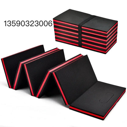 Green EVA foam folding kneeling mat unfolded on a garage floor