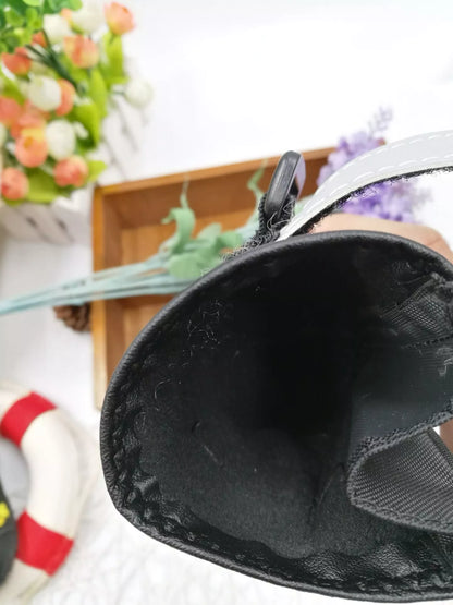 Black waterproof dog shoes with non-slip soles and adjustable fuzzy belt