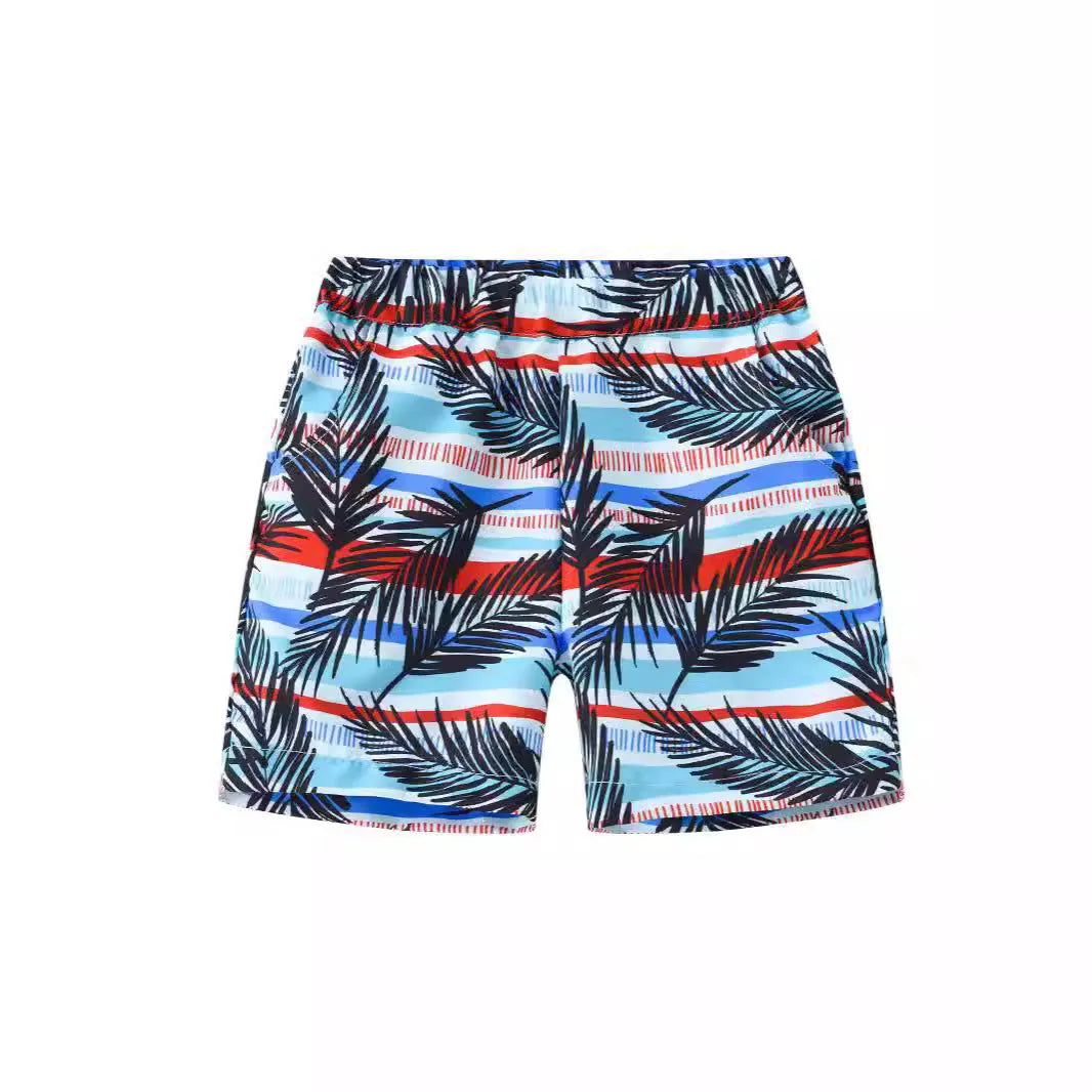 Multi-colour printed beach shorts with hairband belt on a mid-waist, shown in a casual summer style.