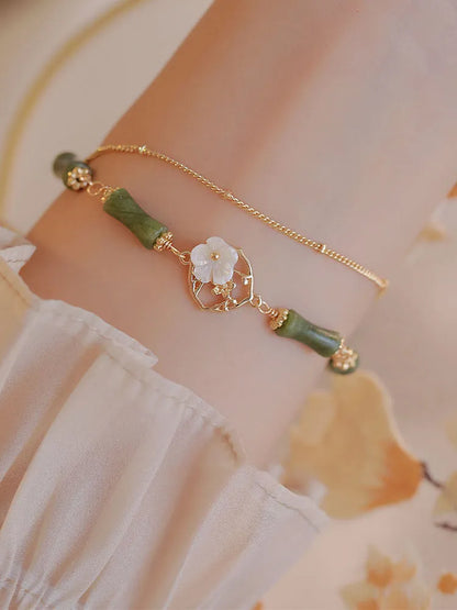Natural olivine bracelet with Chinese double layer design featuring twin bells of Ireland olive branch elements