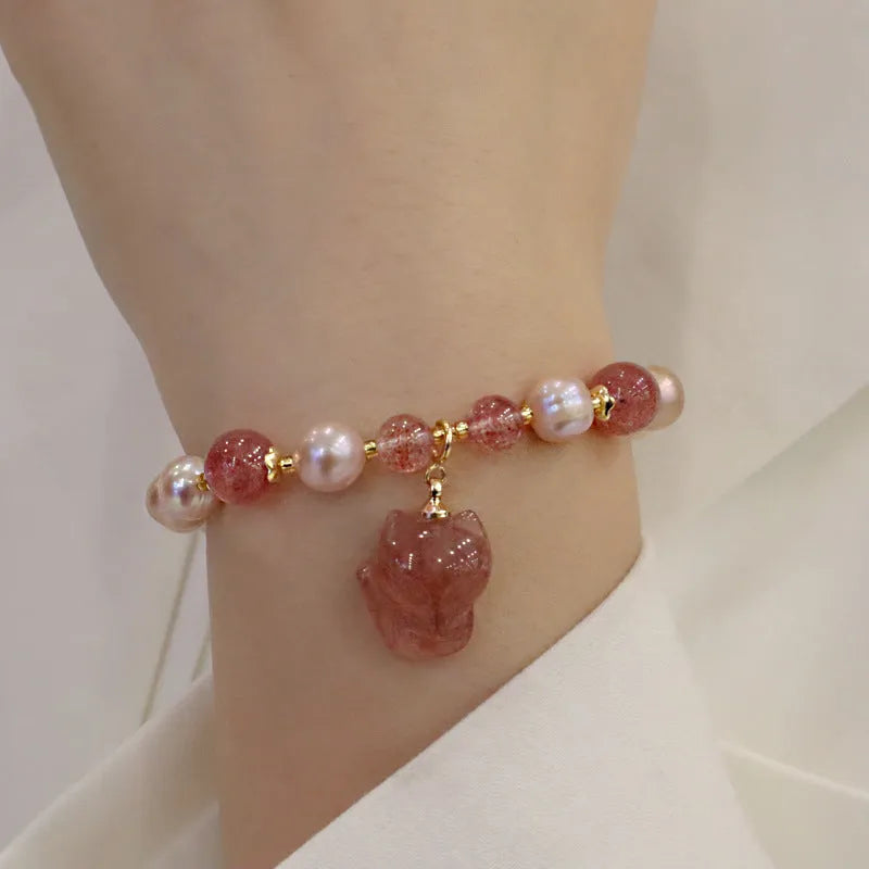 Women's light pink freshwater pearl bracelet with strawberry quartz stones and fox charm