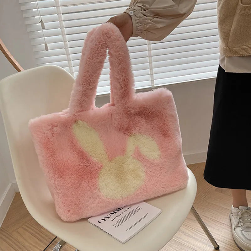 Soft plush tote bag with cartoon rabbit ears in solid colours like beige, pink, and black.