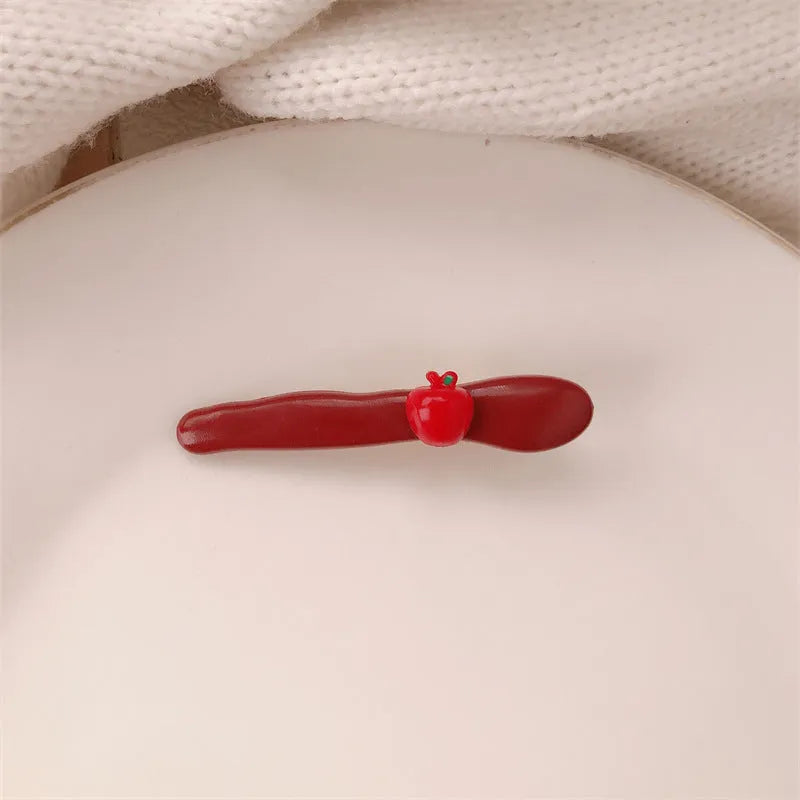 Red love heart-shaped hair barrette clip with retro white dots on a willow leaf-shaped base.