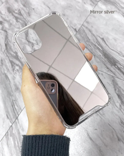 Silver mirrored phone case for Apple iPhone on a table, showing reflective back.