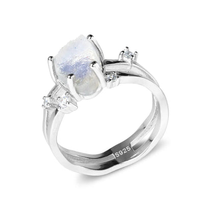 S925 sterling silver ring with an irregular triangular bezel holding a genuine cabochon moonstone, on a model's finger.