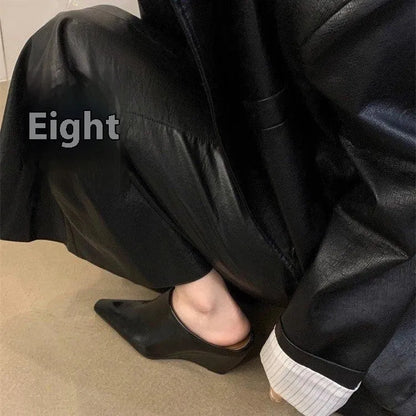 Women's black wind wedge closed toe half slippers showing PU upper and open back.