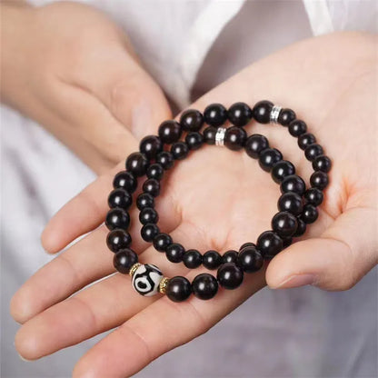 Tibet beads ebony bracelet showing two wooden circles on dark wood with 8mm diameter
